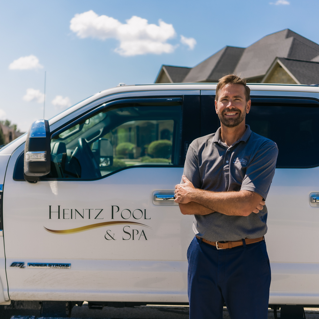 Jerod Heintz standing beside Heintz Pool & Spa company car