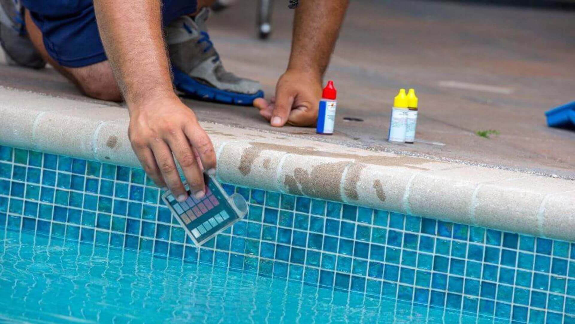 Pool testing kit being used in a swimming pool