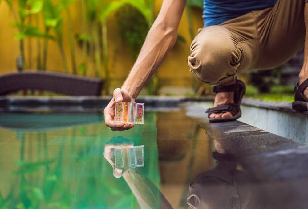 Pool worker checks the pool for safety. Measurement of chlorine and PH of a pool