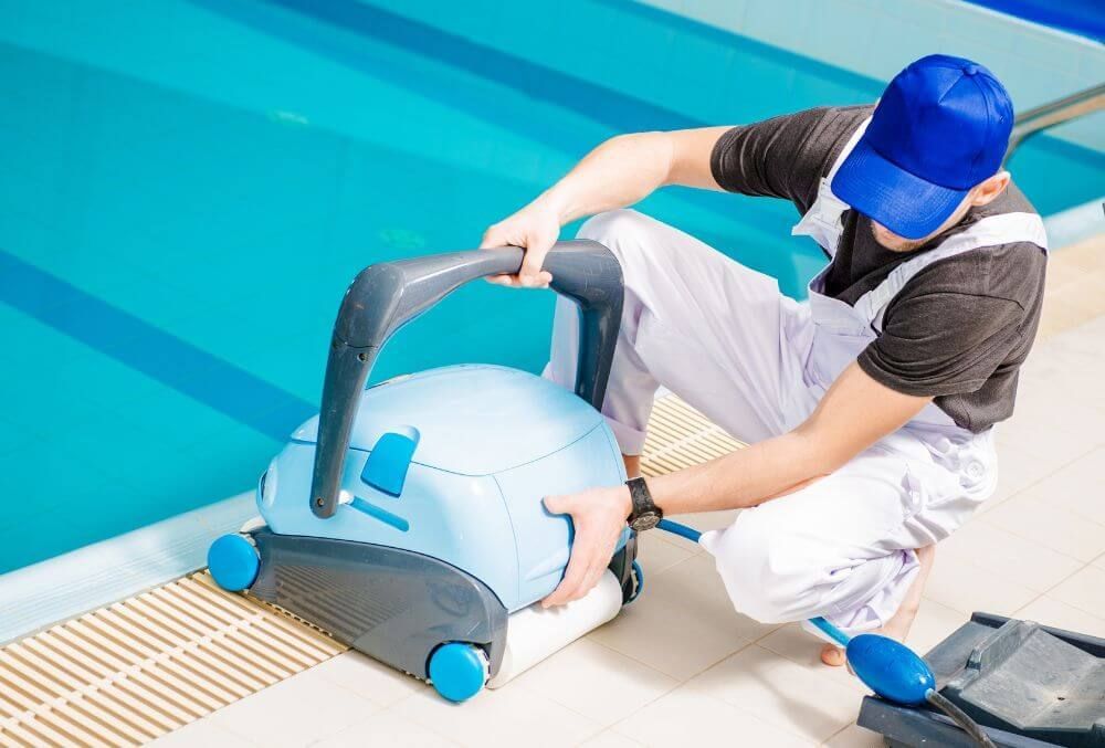 man cleaning the swimming pool