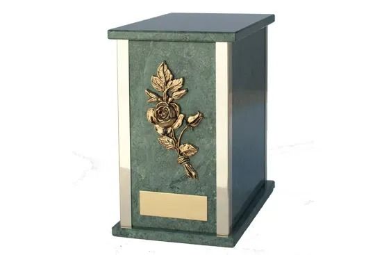 Green and gold decorative pedestal with floral ornament on a white background