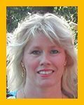 A woman with blonde hair is smiling for the camera in a yellow frame.