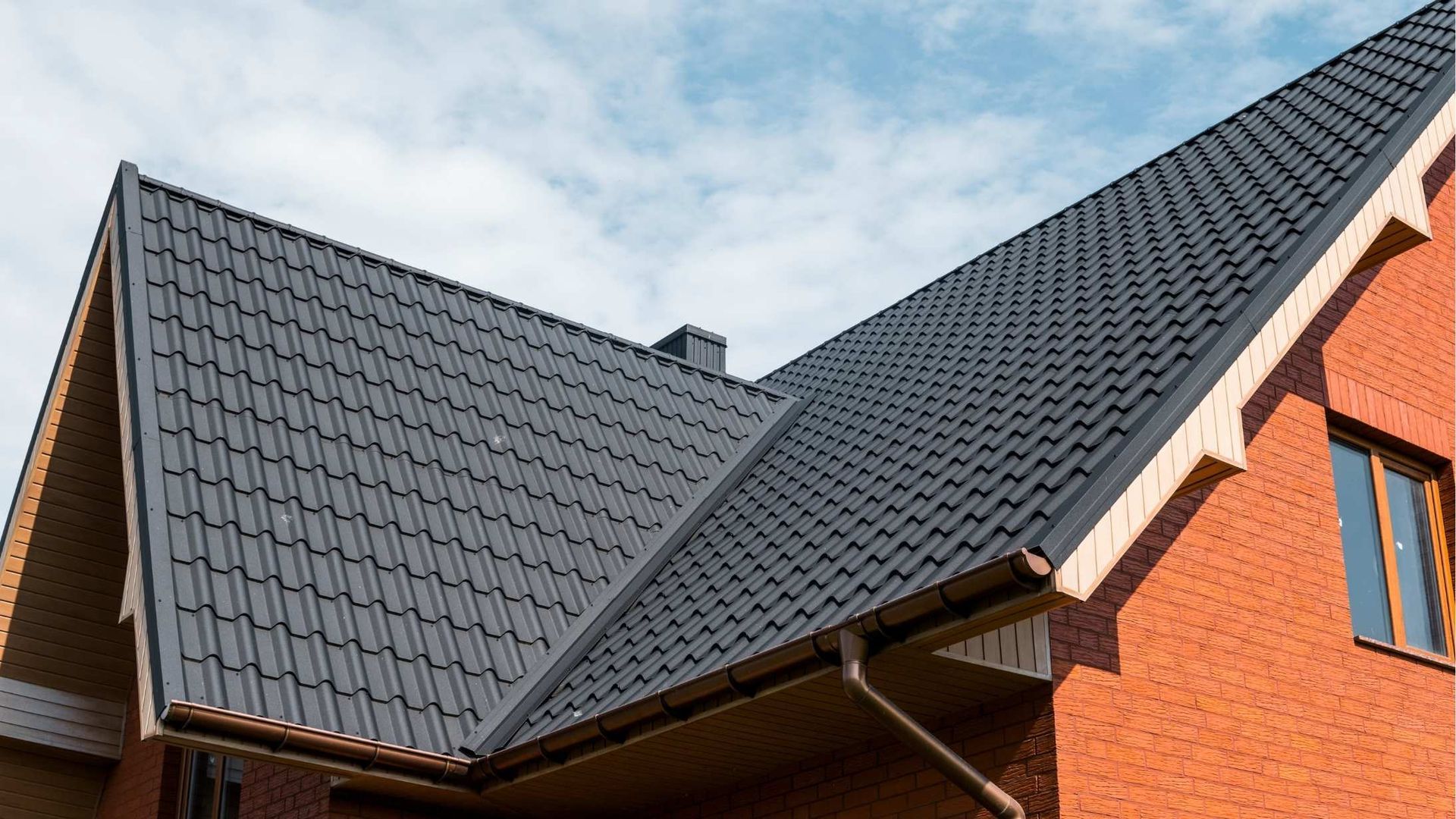residential house with a metal roof and red walls