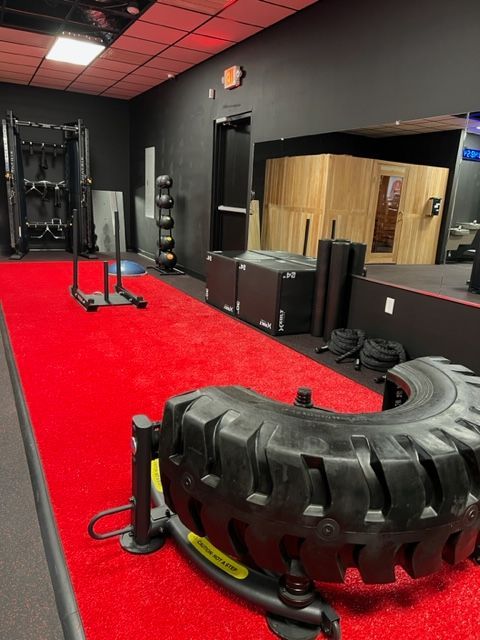 A tire is sitting on a red carpet in a gym