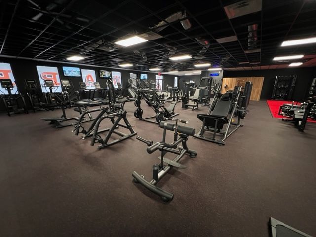 A large gym filled with lots of exercise equipment