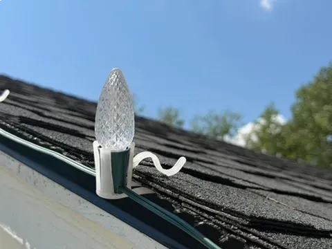 holiday light installation clips securing Christmas lights