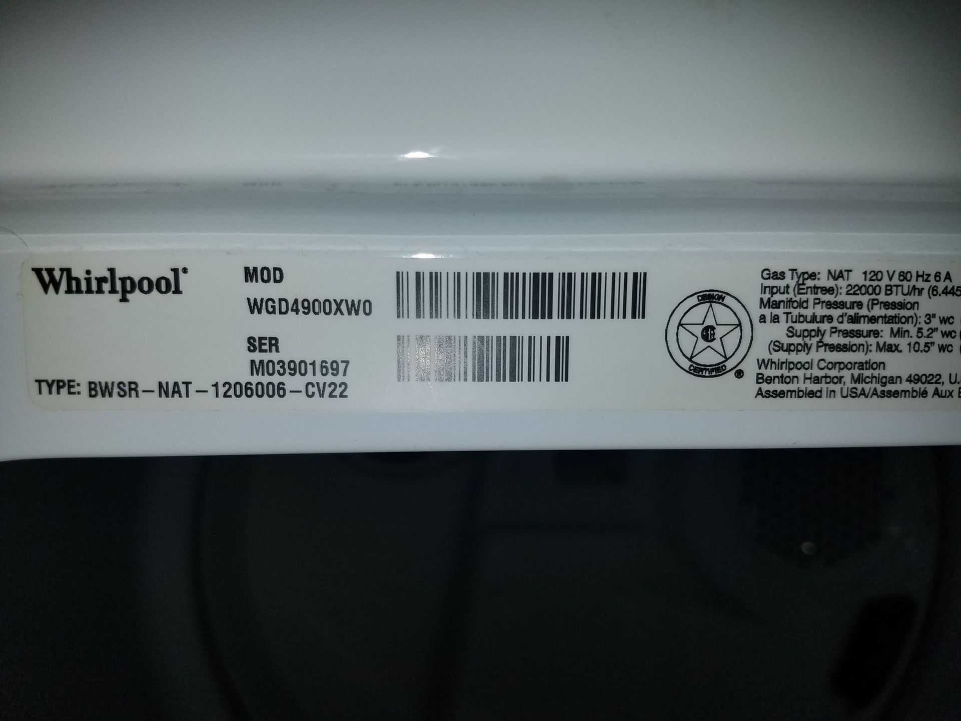 Close-up of a Whirlpool appliance label with model and barcode information.