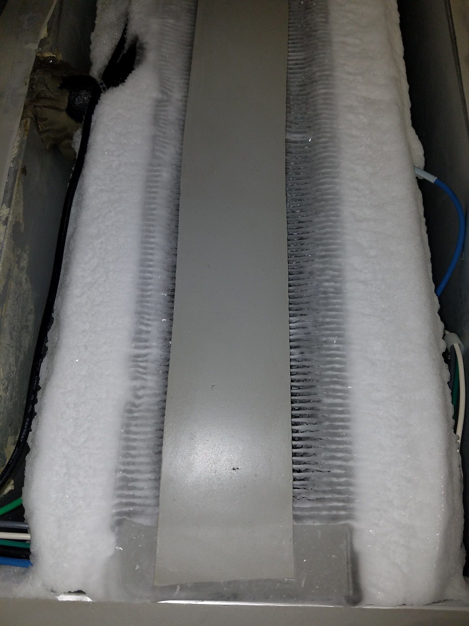 Foam padding wrapped around a vertical metallic panel with wiring visible on the sides