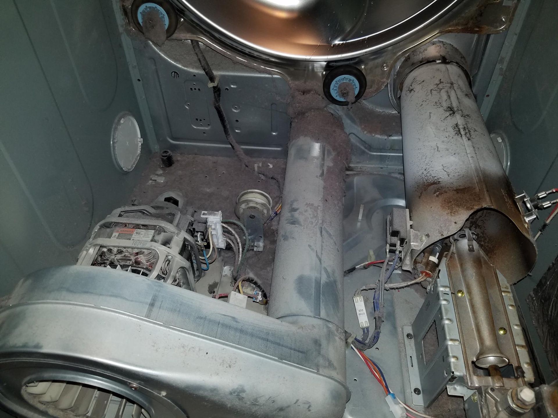 Interior of a metal machine with exposed motor, wiring, and cylindrical components