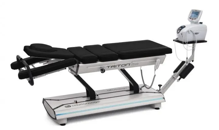 Black medical examination table with adjustable sections and a control unit on the right
