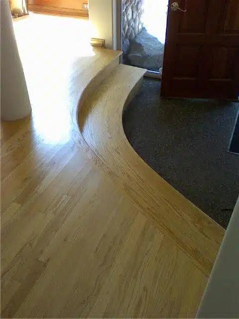 A wooden floor with a door in the background