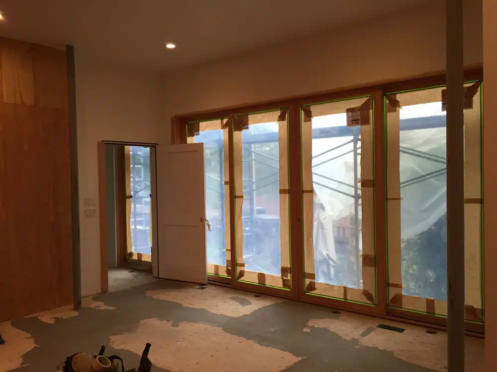 A room with a lot of windows and a door.