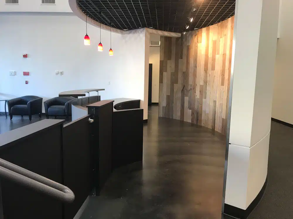 A large empty room with chairs and tables in it.