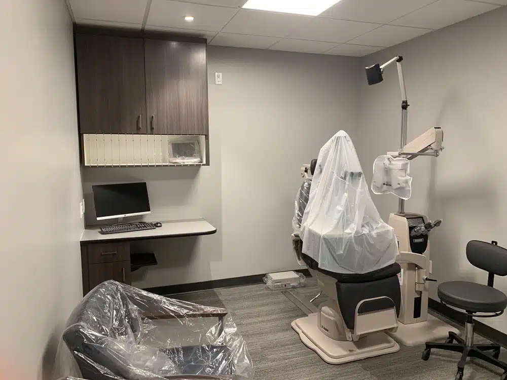 A dental office with a dental chair and a computer.
