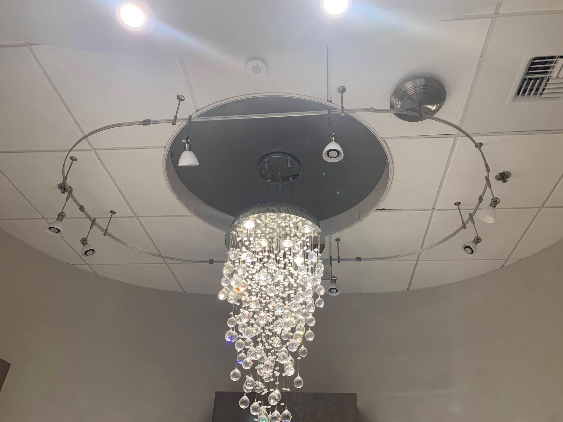 A large chandelier is hanging from the ceiling of a room.