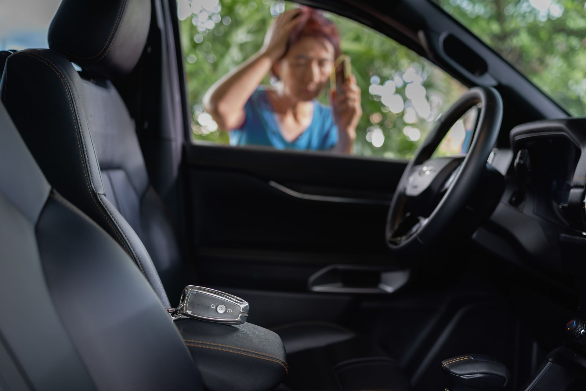 Car interior with a ring on the center console and a blurred person outside the window