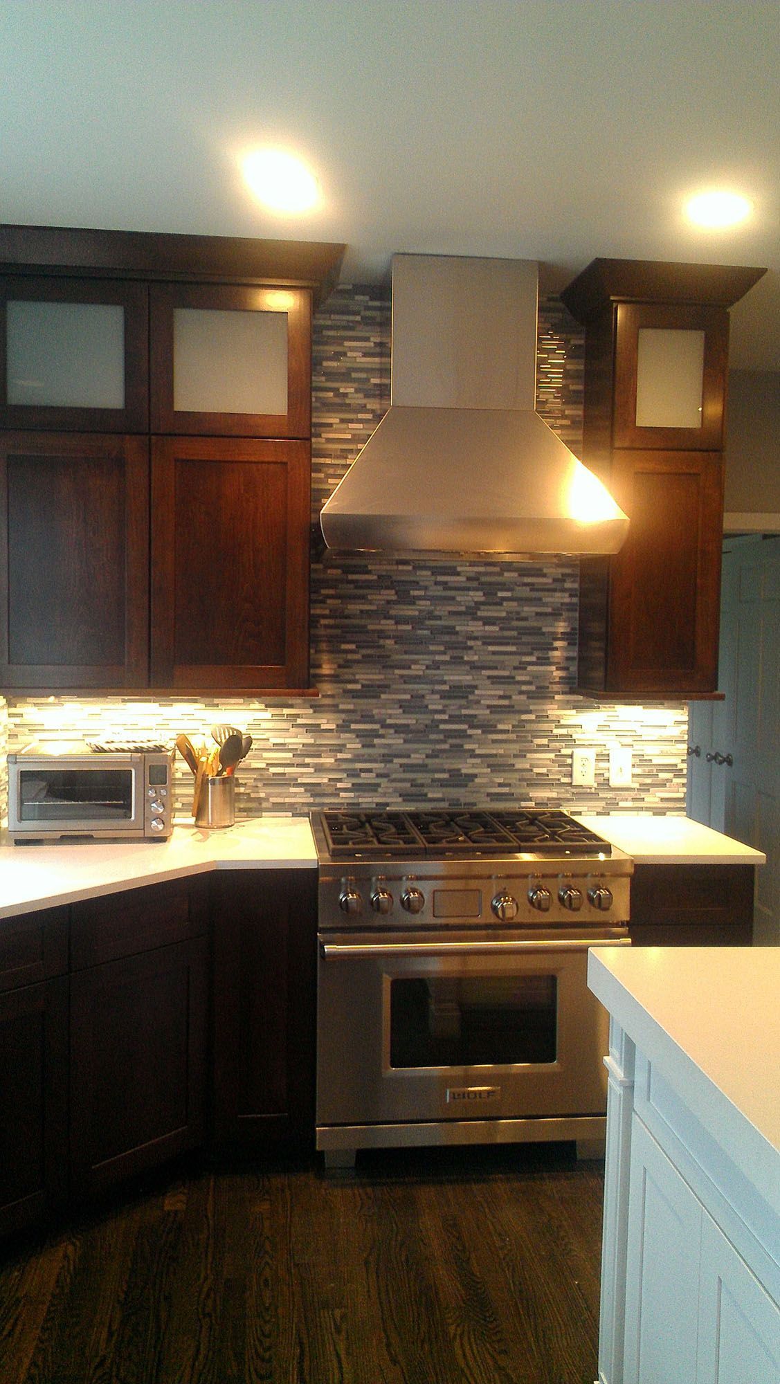 a kitchen with stainless steel appliances and wooden cabinets .