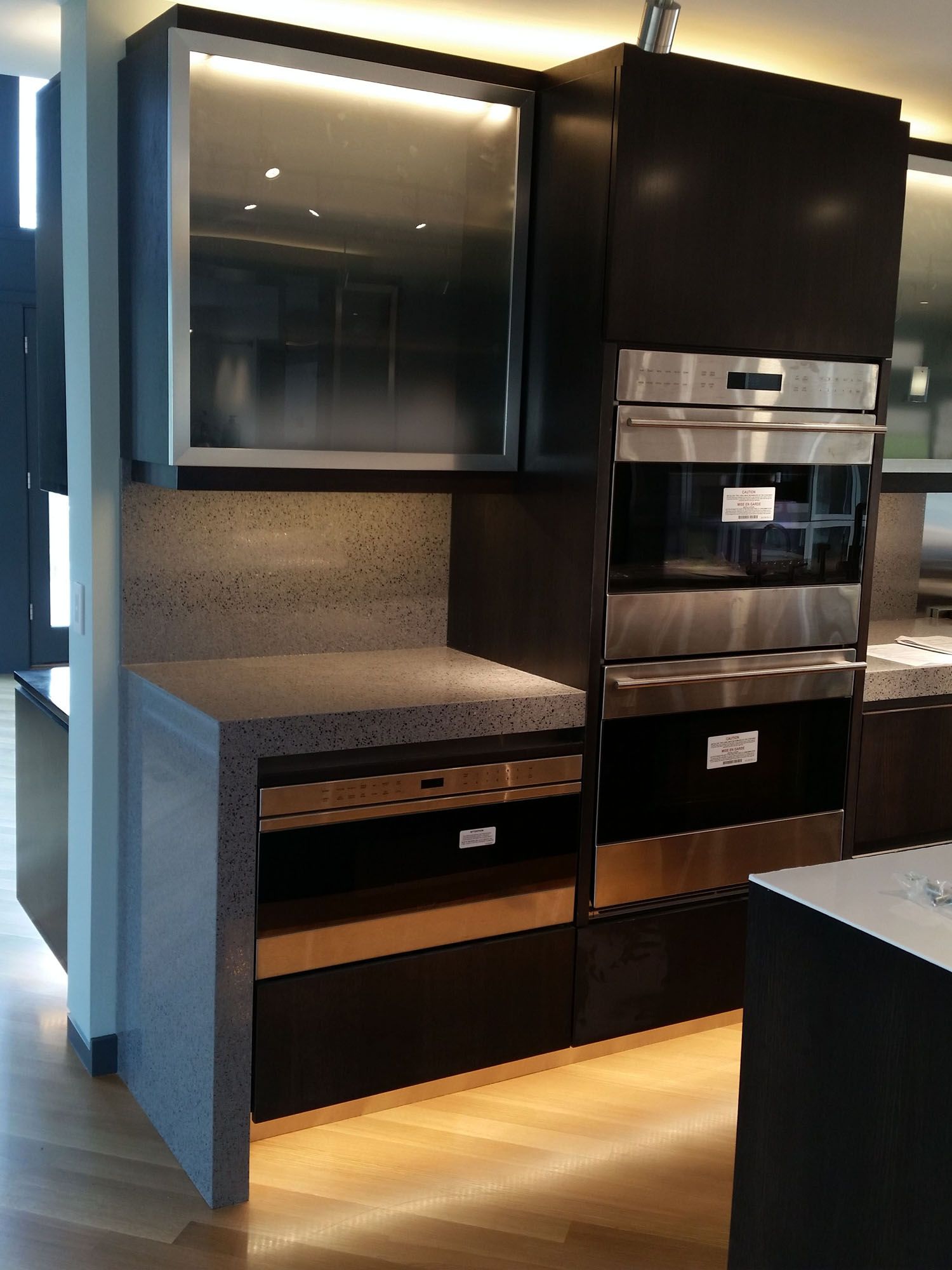 a kitchen with black cabinets and stainless steel appliances