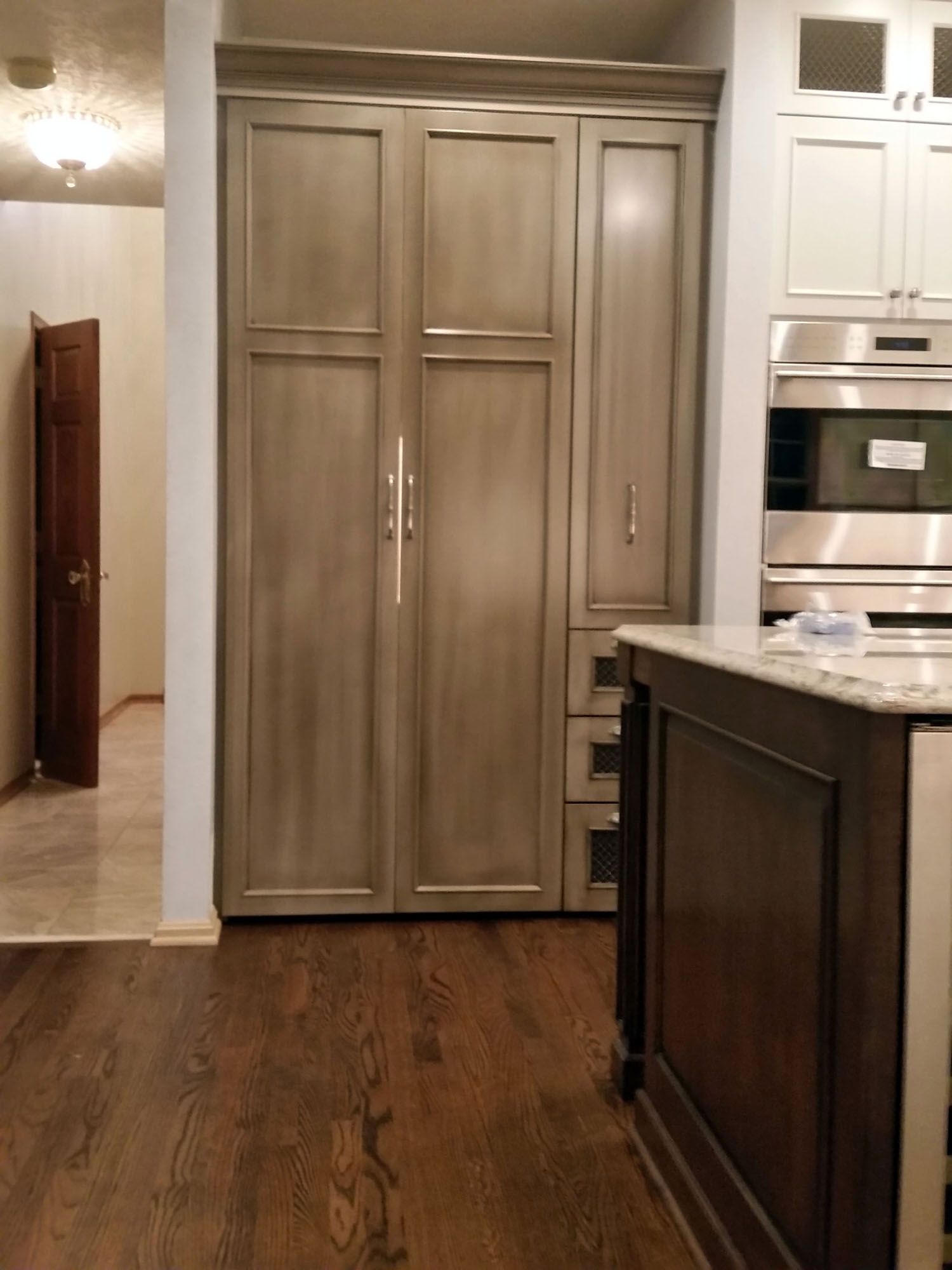 a kitchen with stainless steel appliances and wooden cabinets