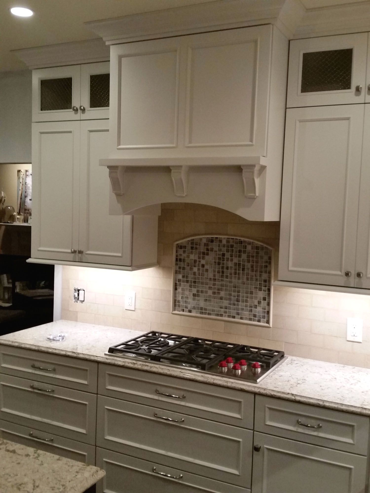 a kitchen with white cabinets and a stove top oven .