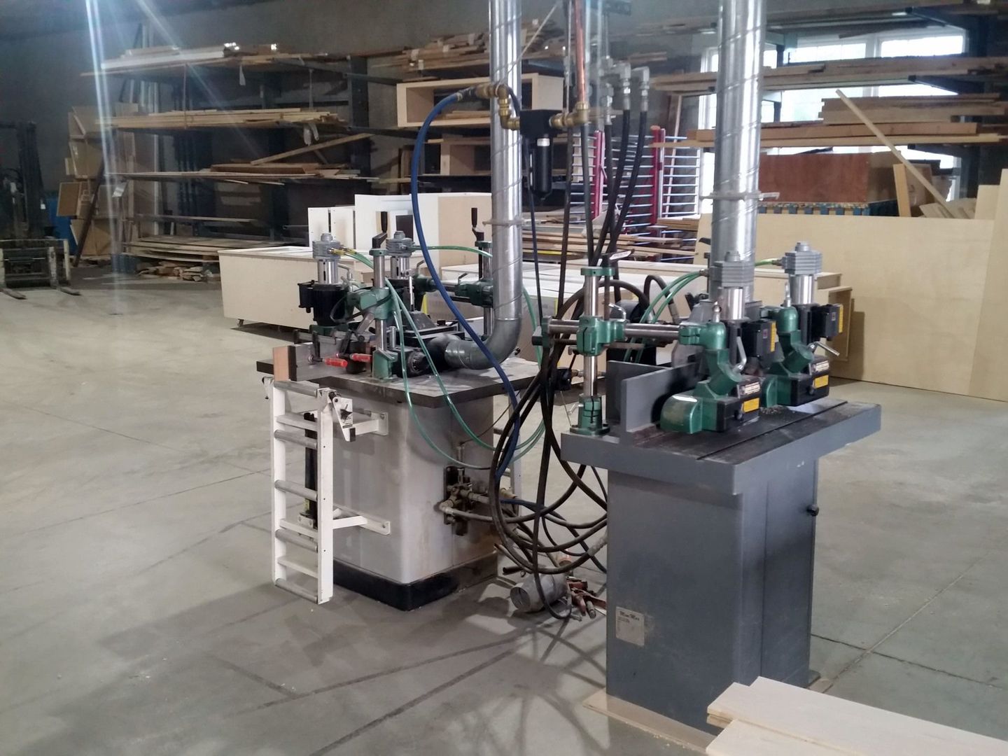 a machine in a warehouse with a ladder attached to it