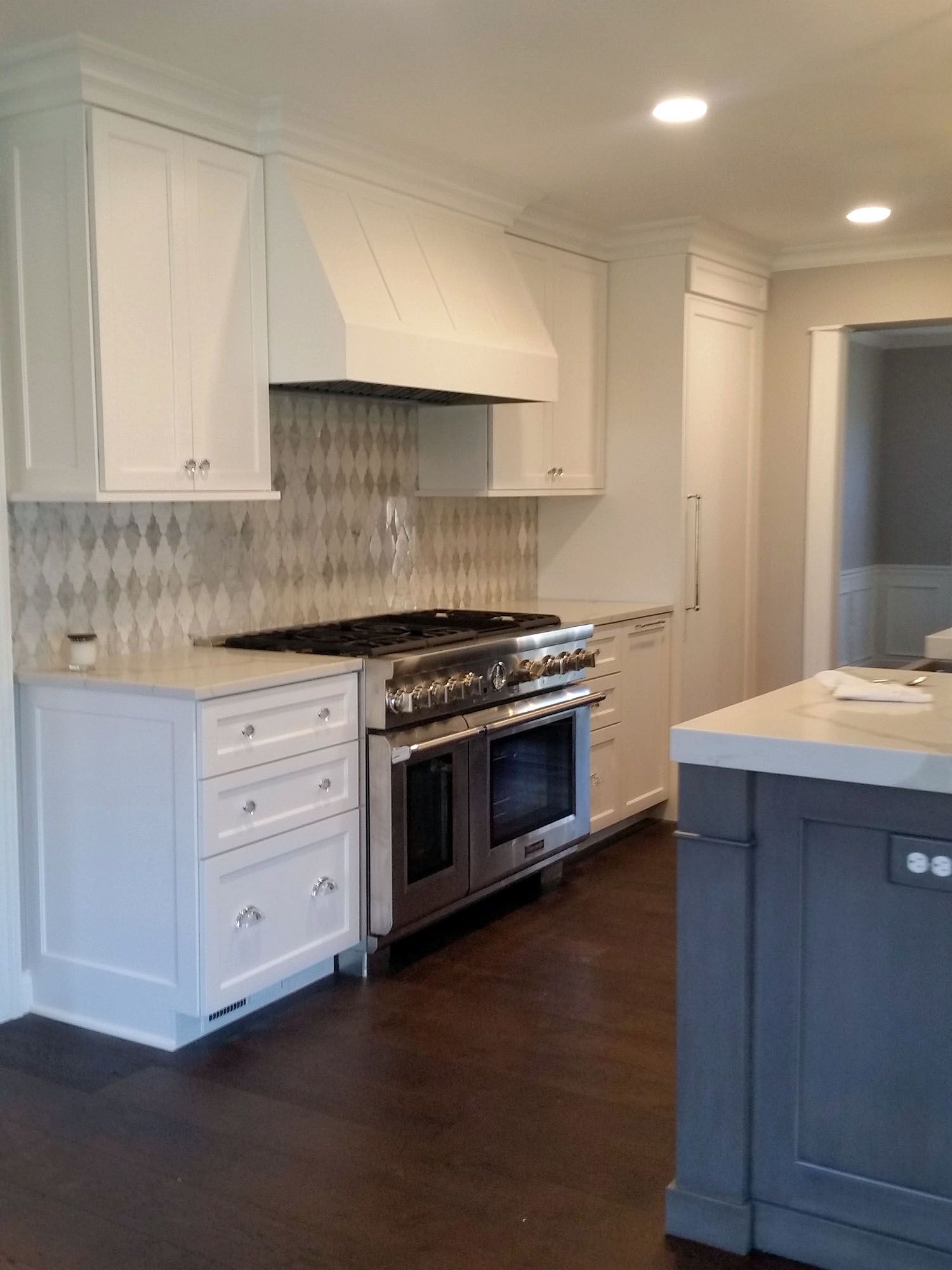 a kitchen with stainless steel appliances and white cabinets.
