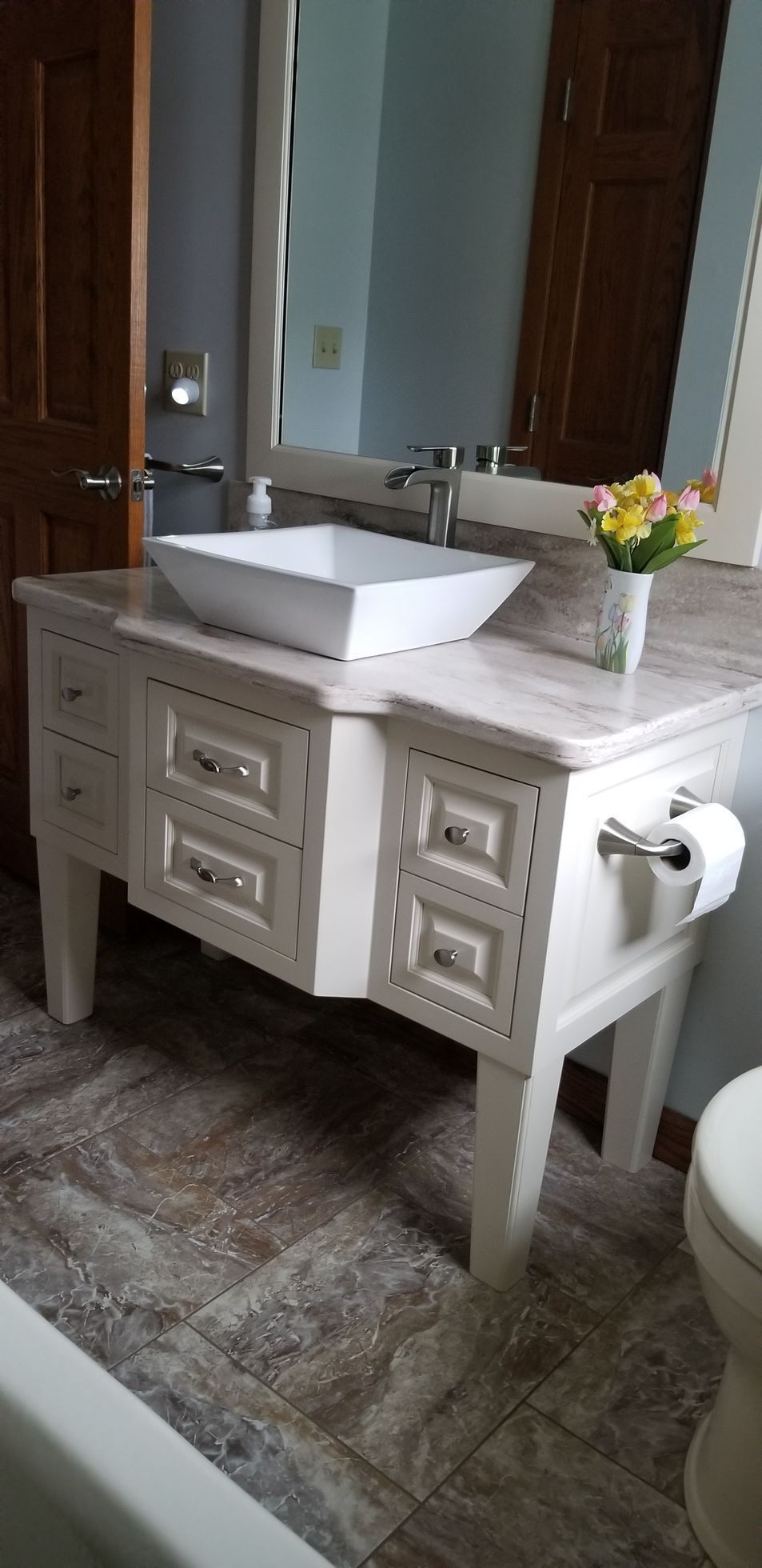 a bathroom with a sink a mirror and a walk in shower