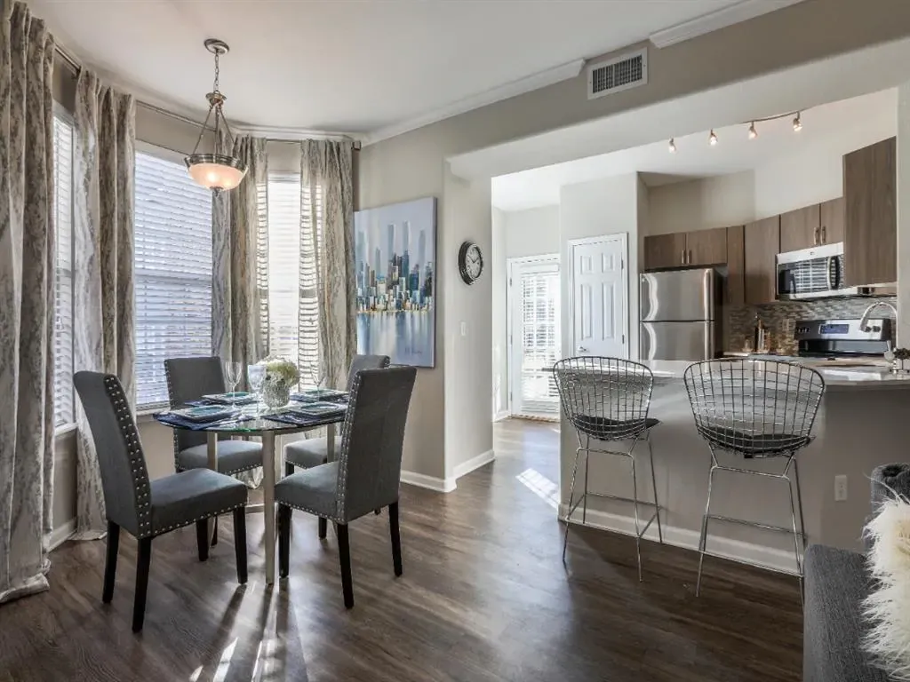 Dining area and kitchen with bar seating.