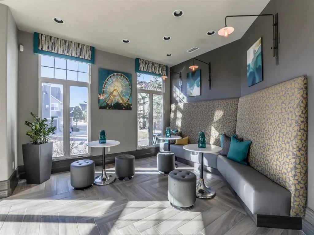 Lounge area with booth seating, tables, and stools.