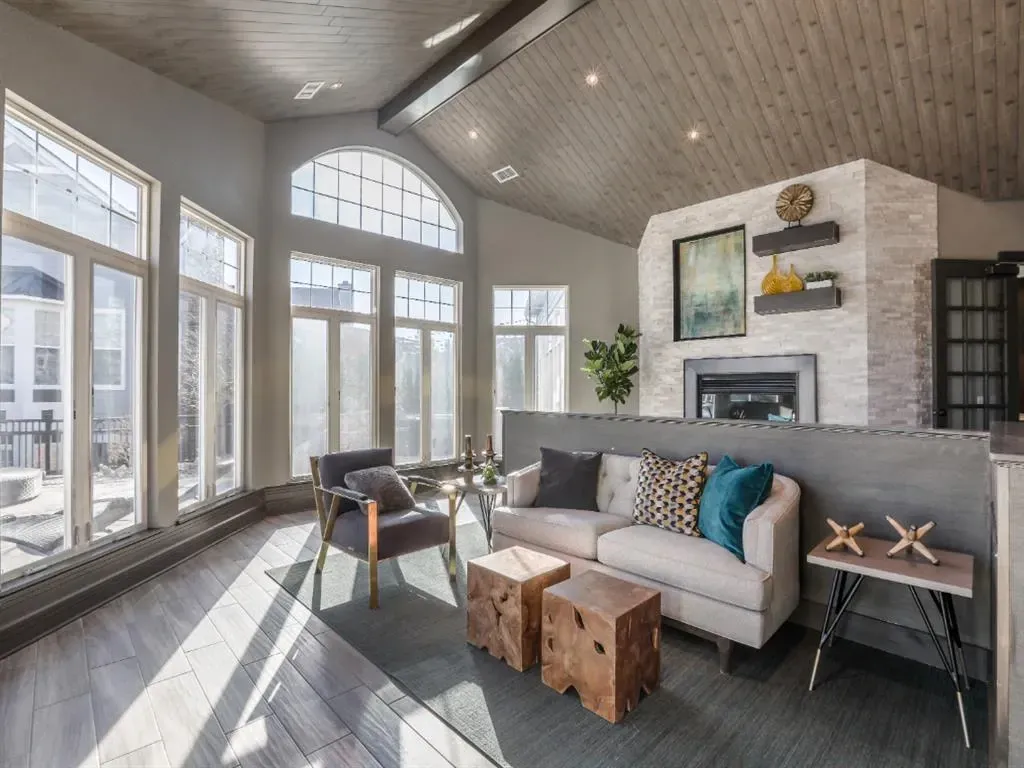 Living area with a couch, armchair, coffee table, and fireplace.