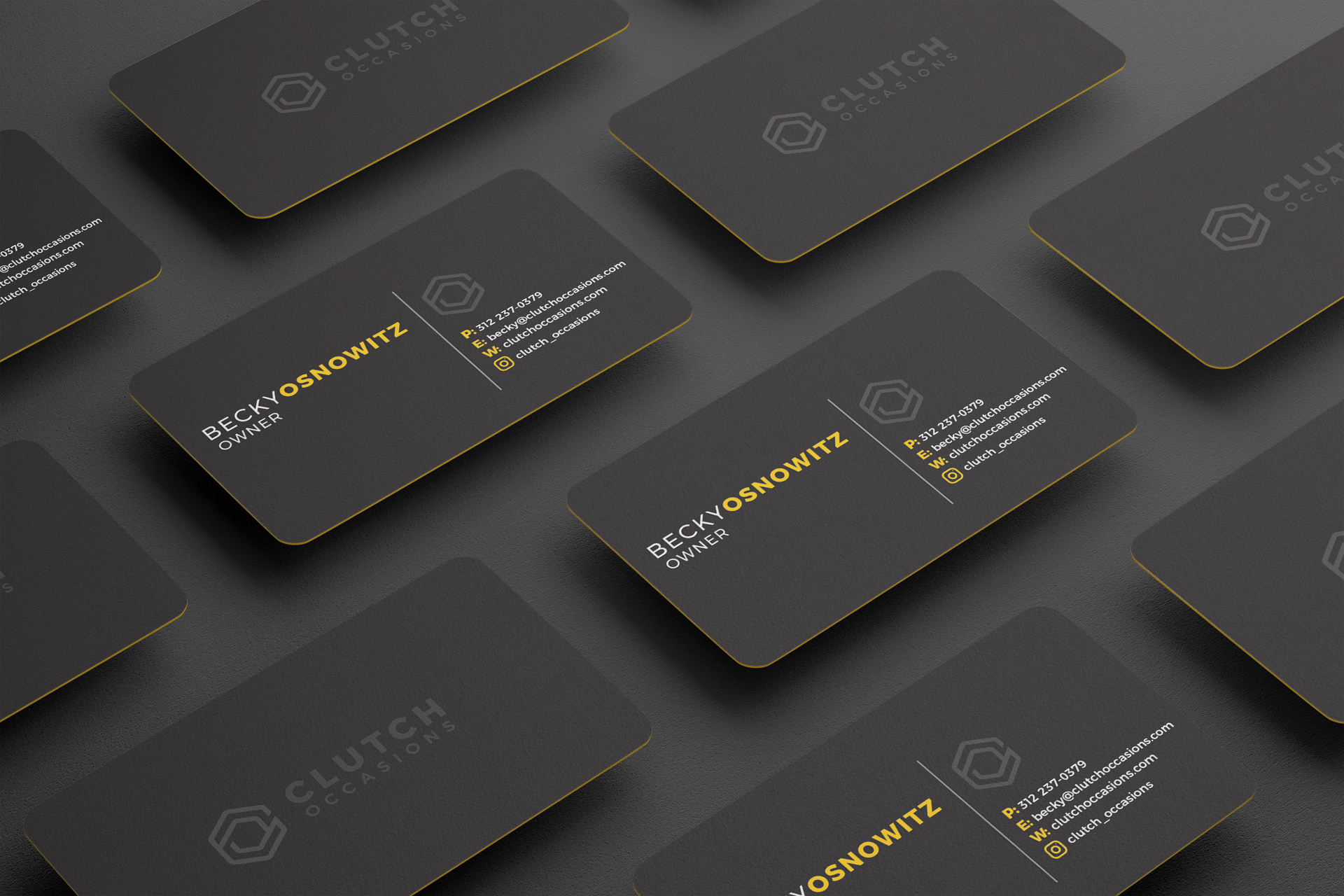 A bunch of business cards are laying on top of each other on a table.