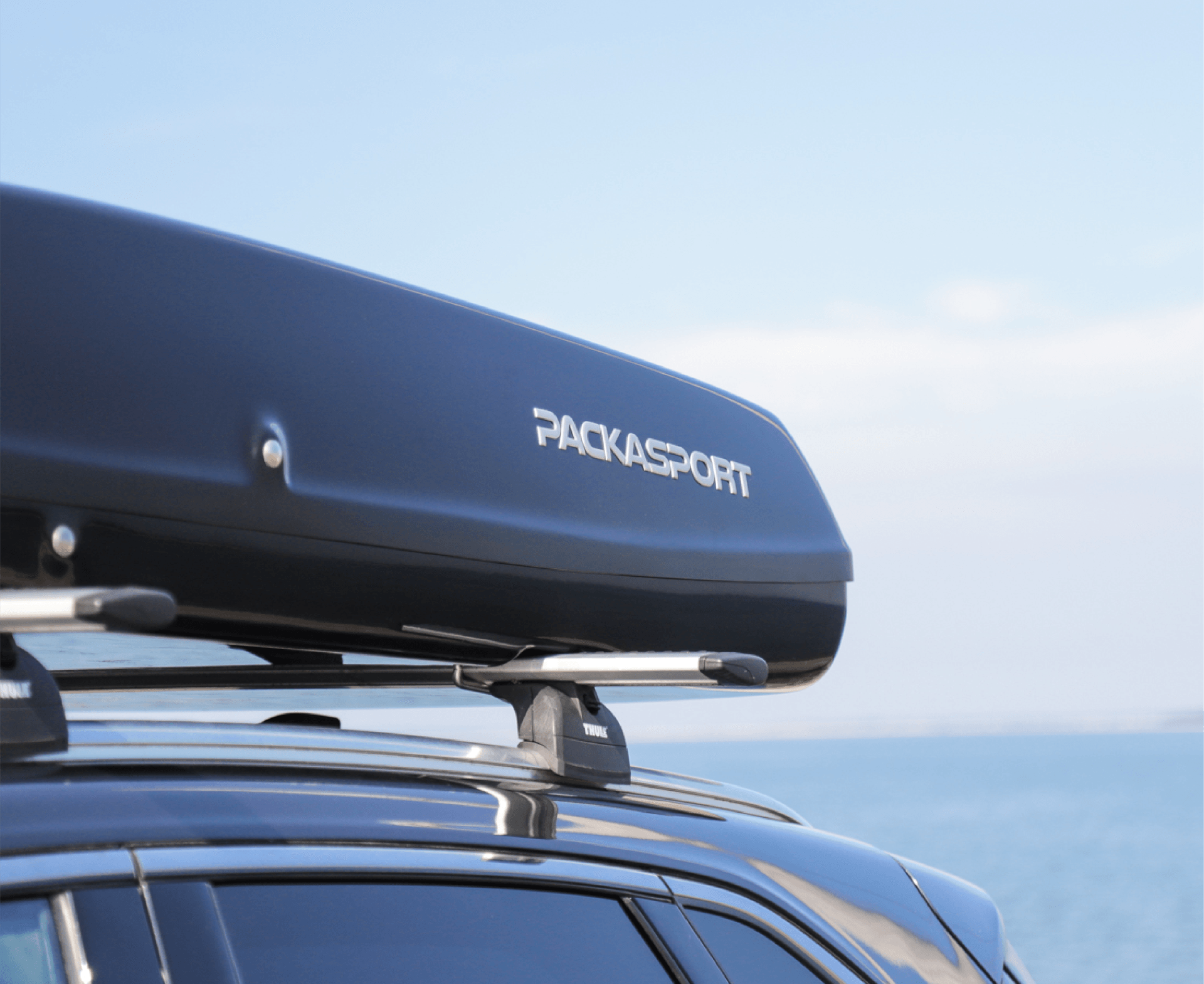 A black roof box with the word packasport on it