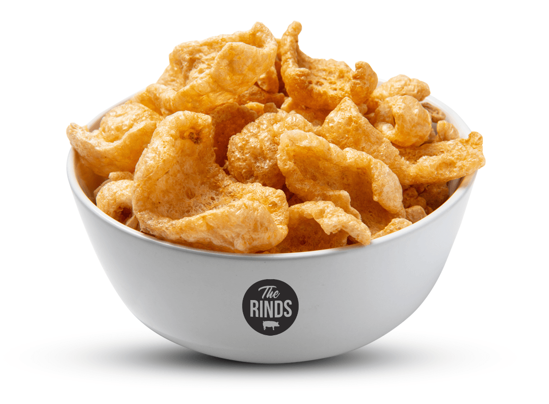 A white bowl filled with fried pork rinds on a white background.
