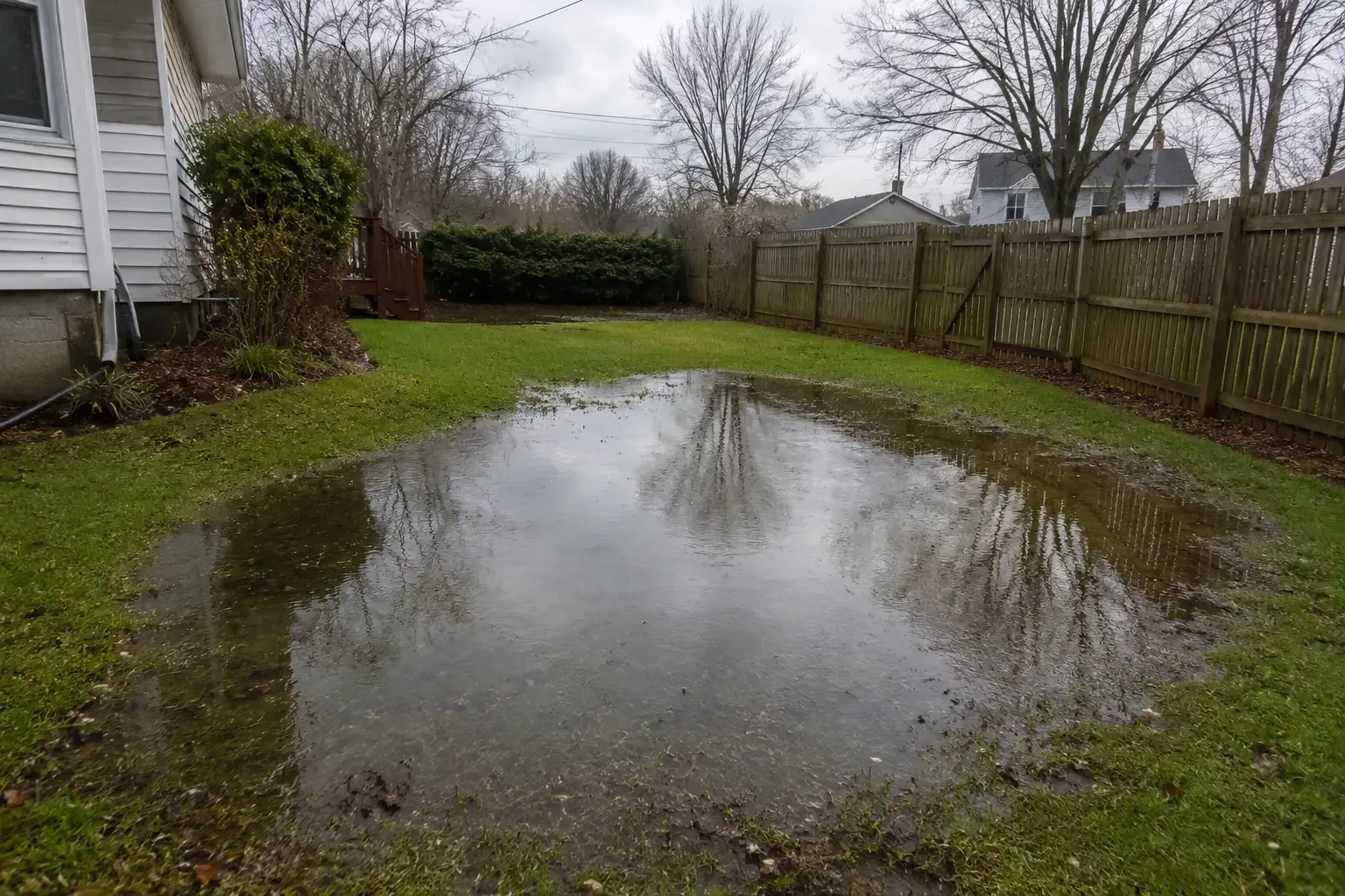 Flooded backyard over a saturated cesspool after heavy rain in Suffolk County, NY.
