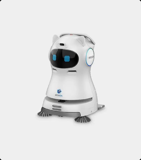 Robot cleaner, gray and black, with a screen displaying a smiling face. Has cleaning brushes, on a white background.