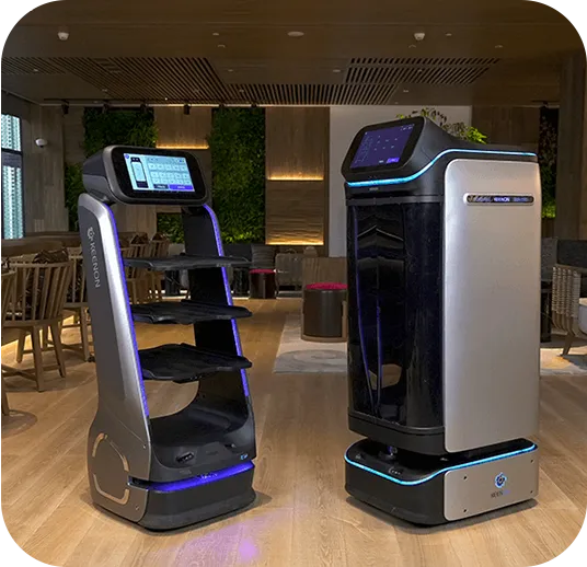 Robot carrying packages in an elevator. The robot is silver and blue with boxes on its shelves. Bright interior.