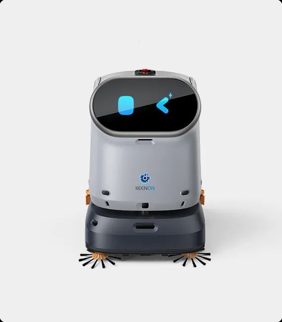 A cleaning robot with a screen displaying a smiling face and an arrow. Gray and dark gray body.