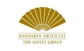 Mandarin Oriental Hotel Group logo with a gold fan emblem and text on a white background