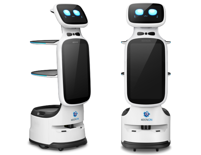 White service robot with shelves, blue eyes on screen, standing on a gray platform in front of a gray background.