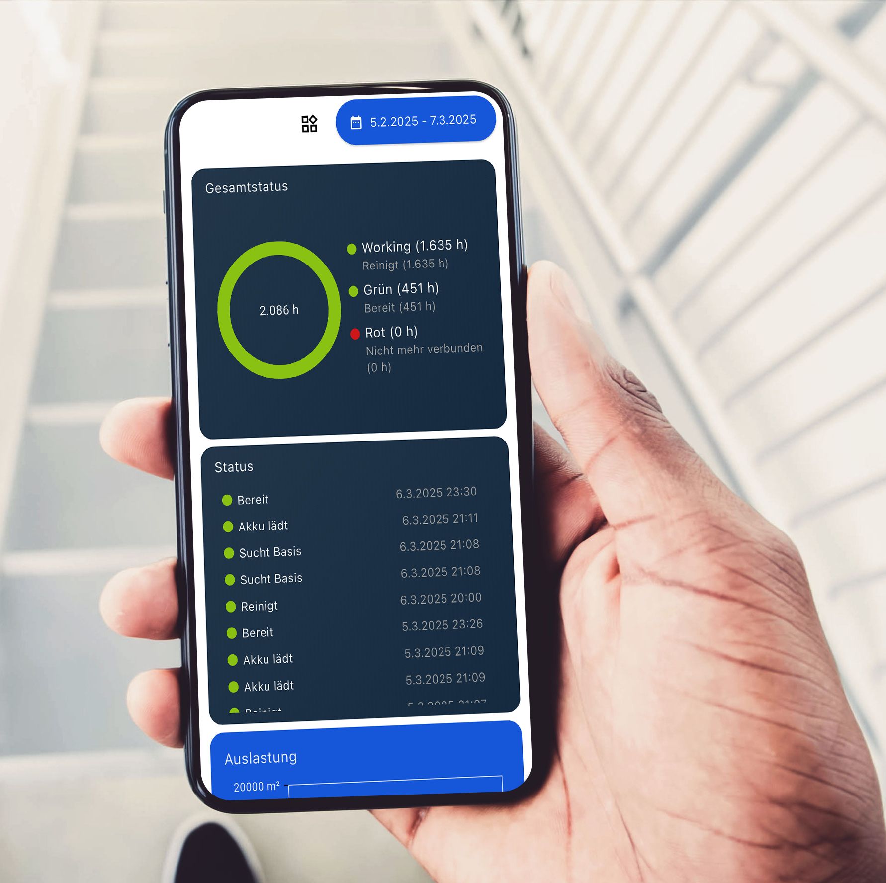 Hand holding a smartphone showing a dark analytics dashboard with charts and a blue header