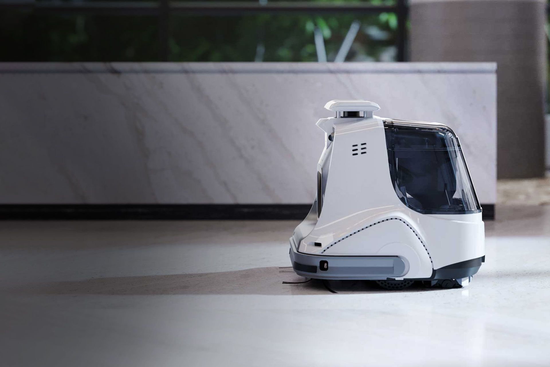 White autonomous floor-cleaning robot in a modern building hallway.