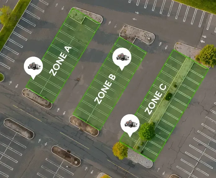 Aerial view of a parking lot with three marked green zones labeled A, B, and C.