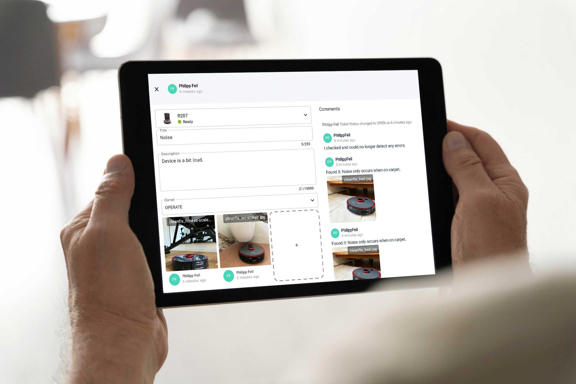 Hands holding a tablet showing a two-column app interface with photos and messages on screen