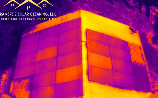 Thermal view of a solar panel array on a building with bright orange and purple heat contrast