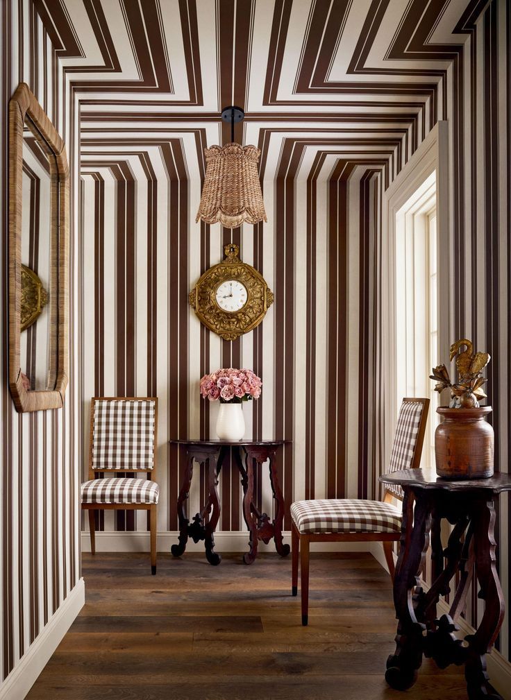 Bold striped wallpapered ceiling and walls with pendant light and decorative mirror