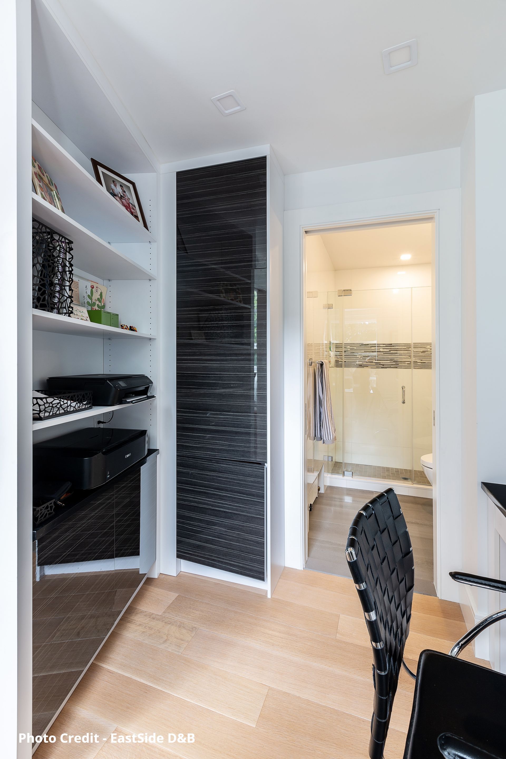 Minimal interior Home Office with white walls, dark accent wall, and recessed ceiling lights