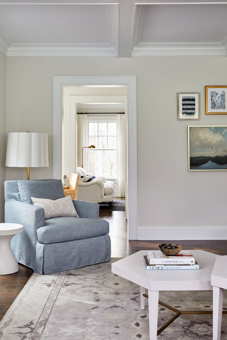 Classic interior doorway with coffered ceiling, neutral walls, and framed artwork