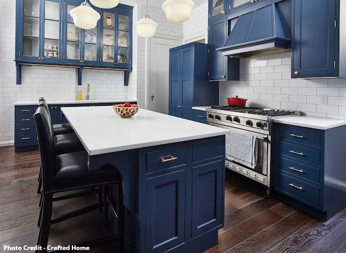 Historic restoration Blue kitchen with white island, subway tile backsplash, range, and pendant lights