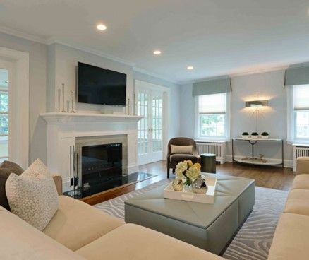 Bright living room with white fireplace, TV, recessed lighting, and soft neutral seating
5	Interior	Living room with white fireplace, mounted TV, city window view, and modern décor
6	Interior	Elegant open living and dining room with chandelier, white cabinetry, and upholstered seating