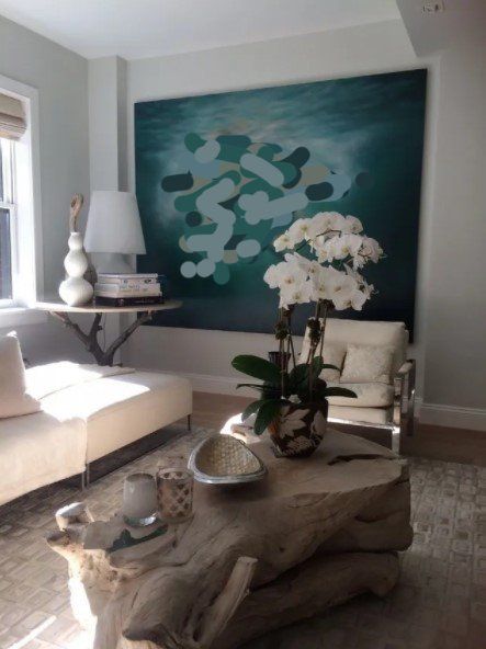 Living Room wall with large blue Nude artwork, white flowers, and decorative accents